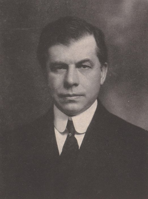 Portrait photograph of Edward M. Bassett in a dark suit, high white collar and tie
