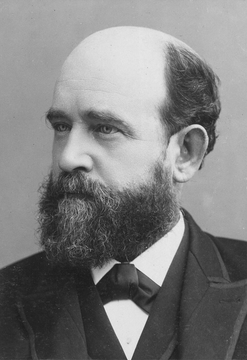 Studio portrait of the economist Henry George, balding, with a full beard and a bow tie