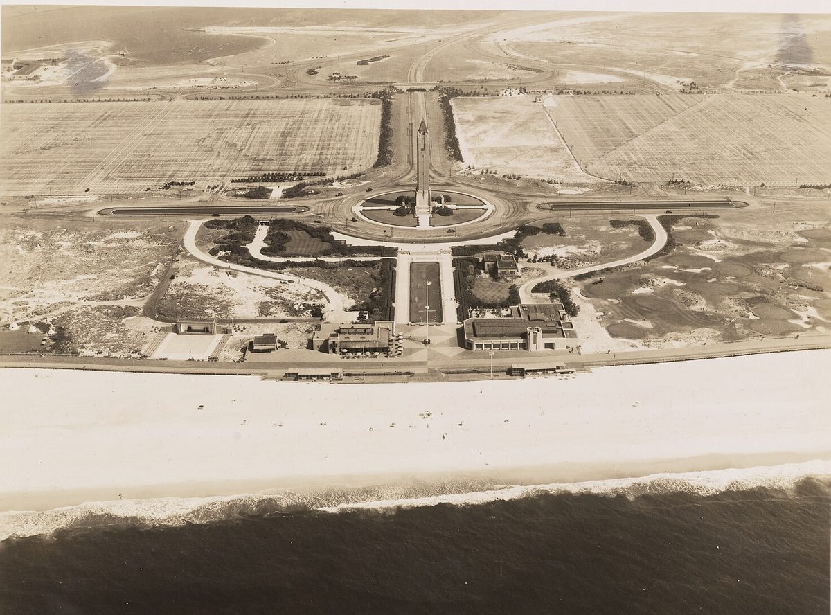 Aerial view of Jones Beach in 1936: wide sand, the boardwalk, bathhouses, the water tower and vast parking fields